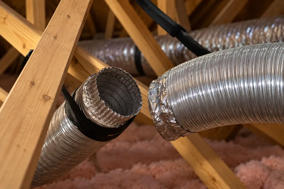 Recreated illustration of a disconnected metallic exhaust duct in an attic